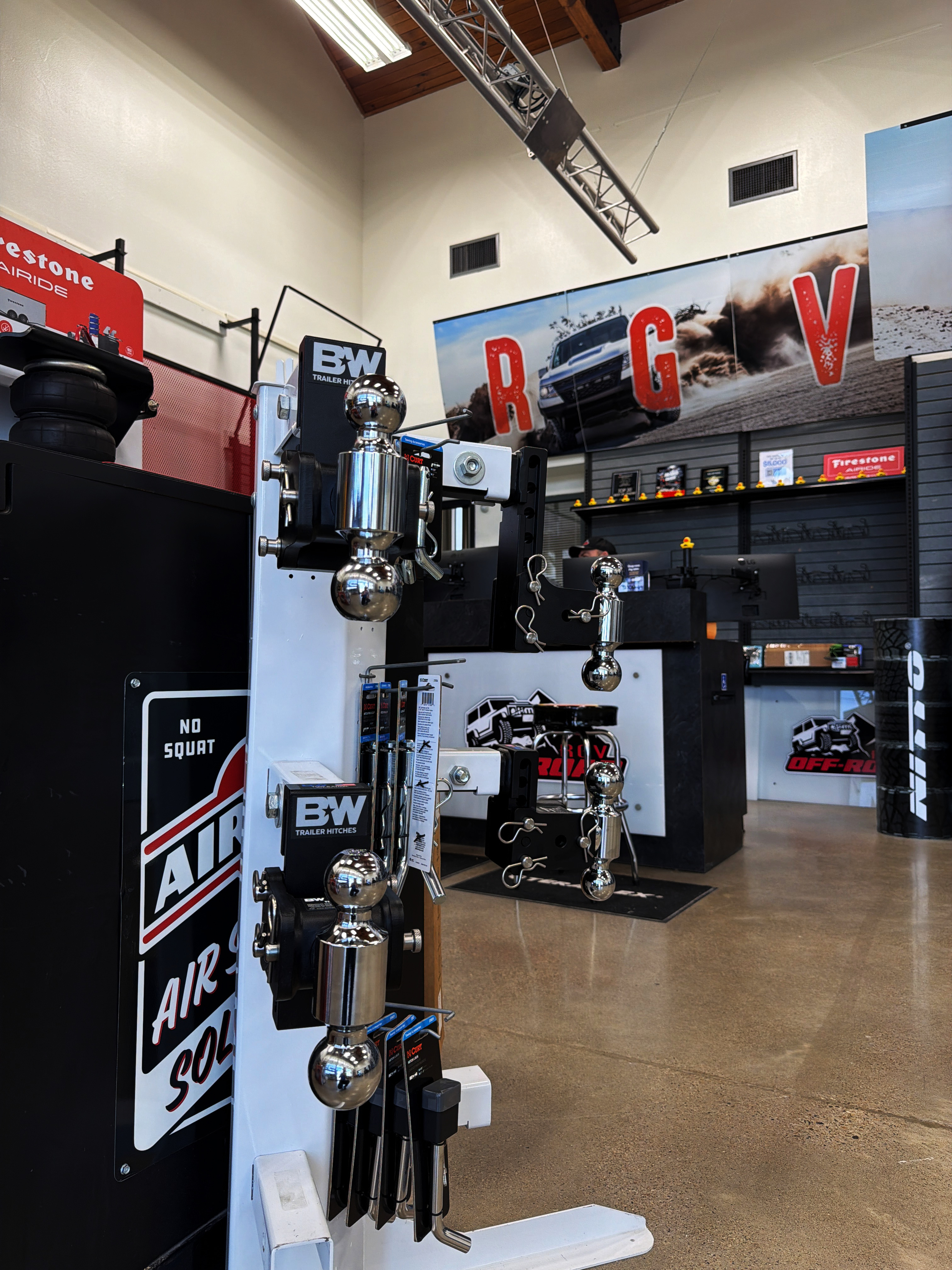 B&W Trailer Hitches display at RGV Off-Road McAllen showroom — turnoverball gooseneck and adjustable ball mounts in stock