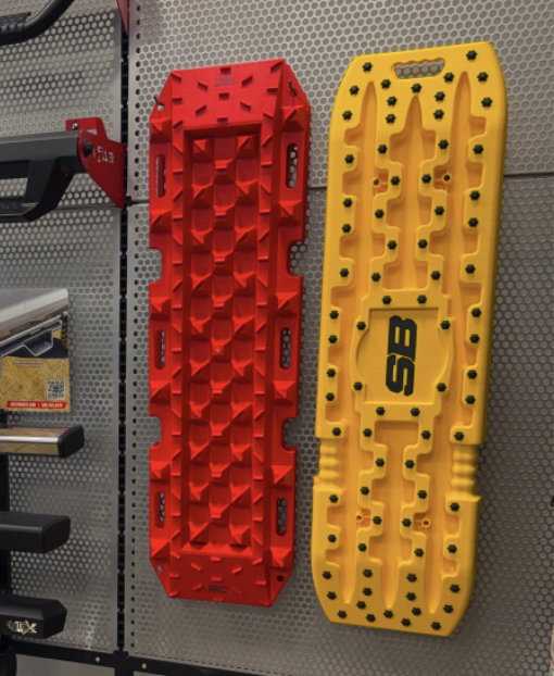 Smittybilt Recovery Traction Boards in red and yellow on display at RGV Off-Road McAllen — off-road recovery gear for sand, mud, snow and trail rescue