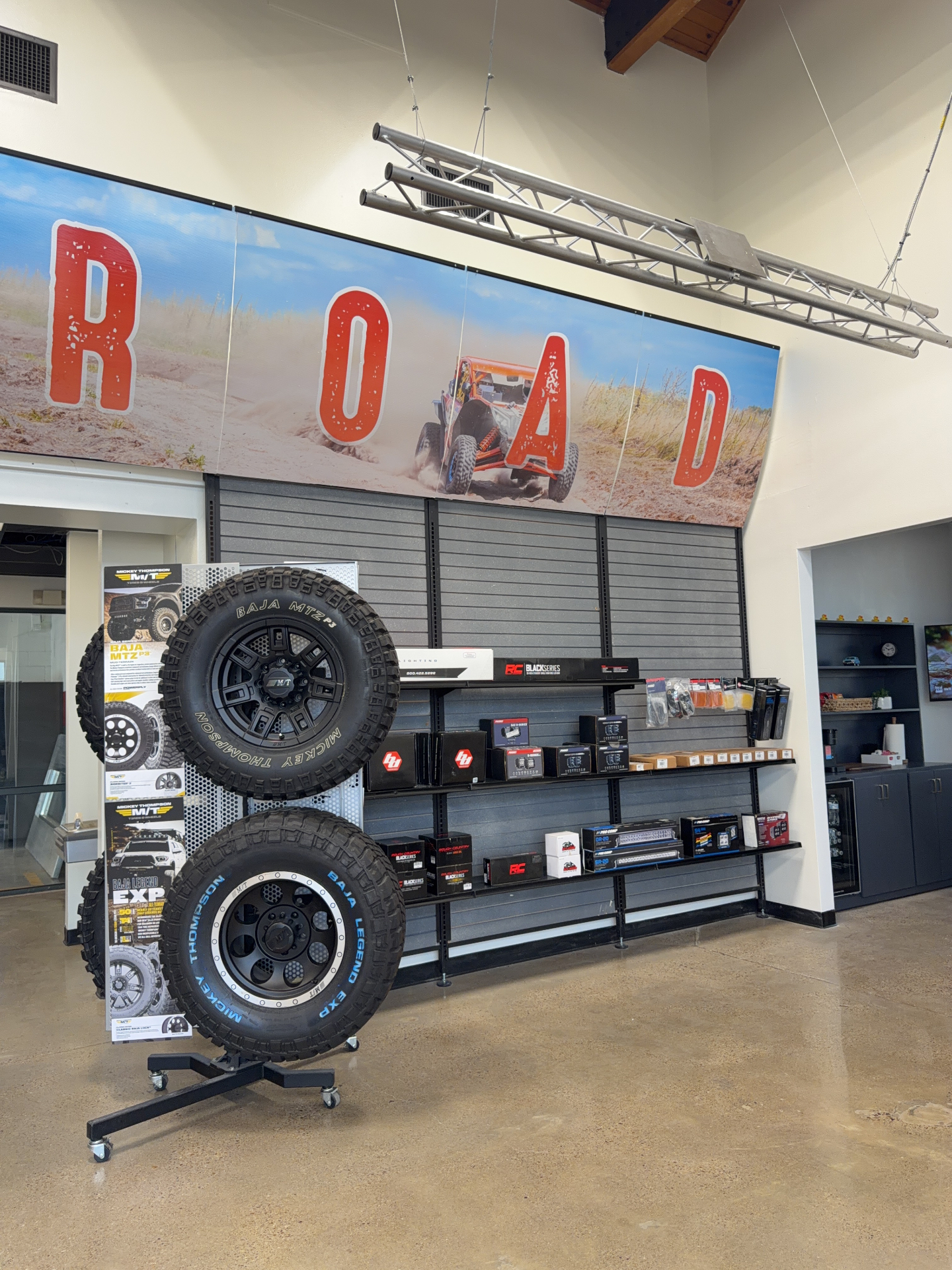 Mickey Thompson Baja MTZ and Baja Legend tires on display with Rough Country lighting boxes inside RGV Off-Road